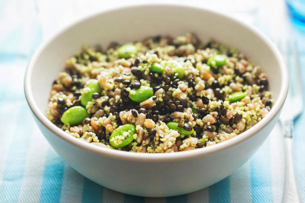 Super wholegrain bowl. Spelt, black lentils, couscous, edamame soybeans. Super wholegrain bowl. Spelt, black lentils, couscous, edamame soybeans. bulgur wheat stock pictures, royalty-free photos & images