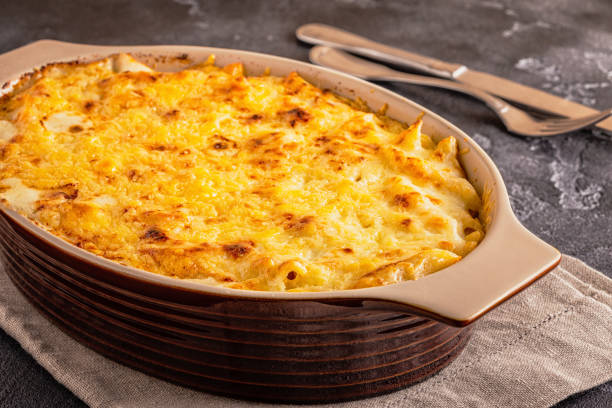 istock Mac and cheese, american style macaroni pasta in cheesy sauce 945436330