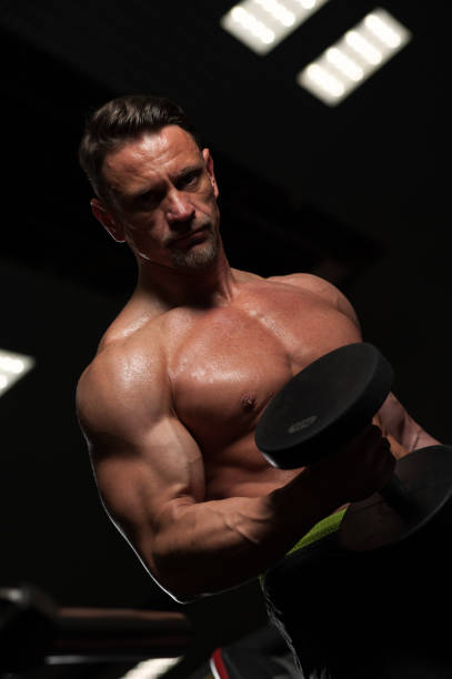 istock Strong mature man working out in the gym 945439398