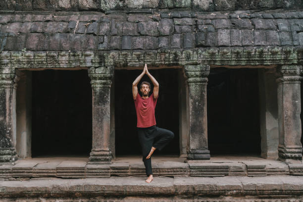 homem fazendo yoga no templo angkor wat - cambodia monk buddhism angkor wat - fotografias e filmes do acervo