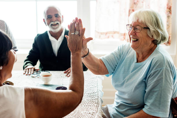 istock Senior women giving each other high five 945439872