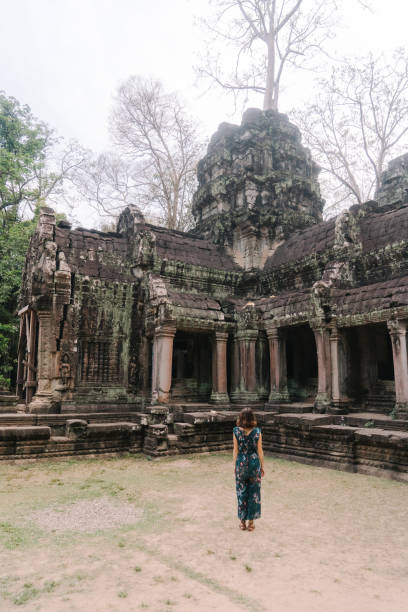 istock Young Caucasian woman   in Ta Prohm temple 945440444