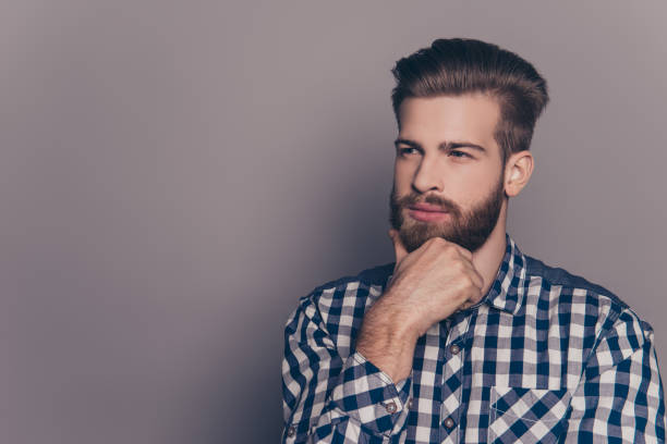 istock Young handsome thoughtful businessman isolated on gray background 945440712