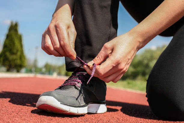 istock Close up image women tying shoes. 945443602