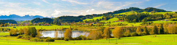 istock panoramic landscape in Bavaria with alps mountain range and lake 945446460