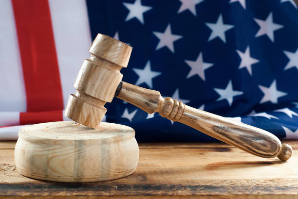 istock Wooden hammer on American flag background, 945452524