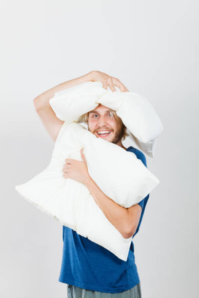 istock Man playing with pillows, good sleep concept 945455624