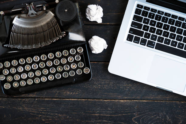 istock Vintage Typewriter and modern laptop 945456386