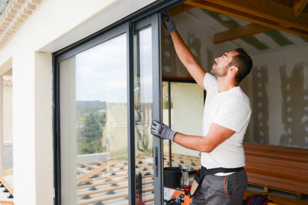 handsome young man installing bay window in a new house construction site handsome young man installing bay window in a new house construction site installing photos stock pictures, royalty-free photos & images