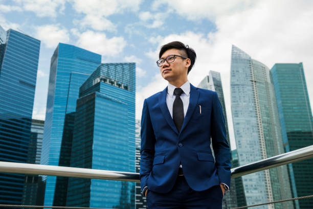 istock Businessman standing outdoor alone thinking 945456812