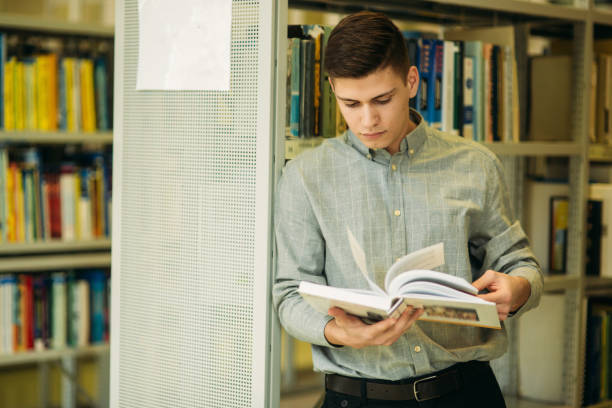 istock Boy student in library want to find some book 945457296