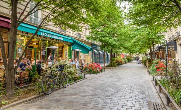 A quiet street with restaurants in the bohemian Marais district of Paris stock photo