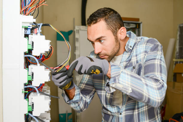 istock handsome young man electrician working on switchboard of house building construction site 945467228