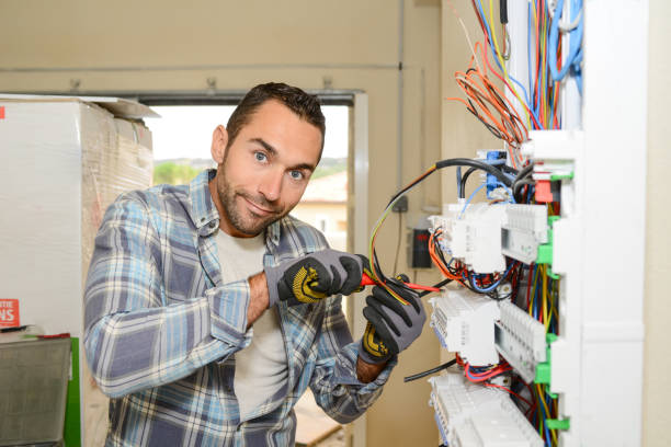 istock handsome young man electrician working on switchboard of house building construction site 945467256