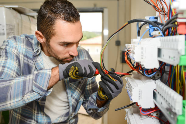 istock handsome young man electrician working on switchboard of house building construction site 945467282