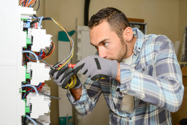 istock handsome young man electrician working on switchboard of house building construction site 945467296