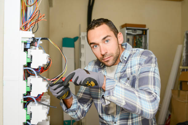 istock handsome young man electrician working on switchboard of house building construction site 945467308
