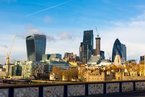 City of London, Financial Services Companies headquarters, The Leadenhall Building, The Gherkin view from south side over Tower Bridge and Tower Hill in golden hour time. London, UK, 11 December 2016