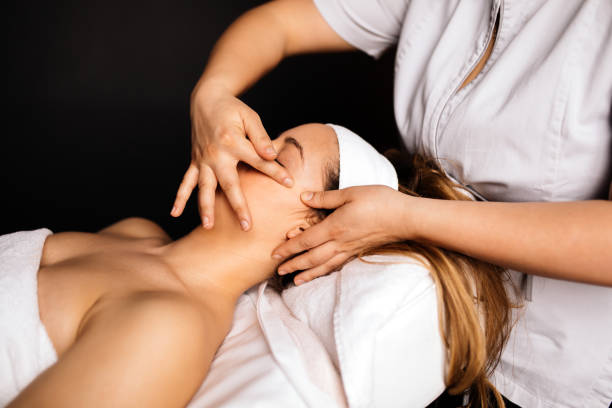 istock Massage therapist massaging woman 945474512