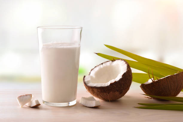 istock Coconut milk in glass with fruit on table in kitchen 945474960