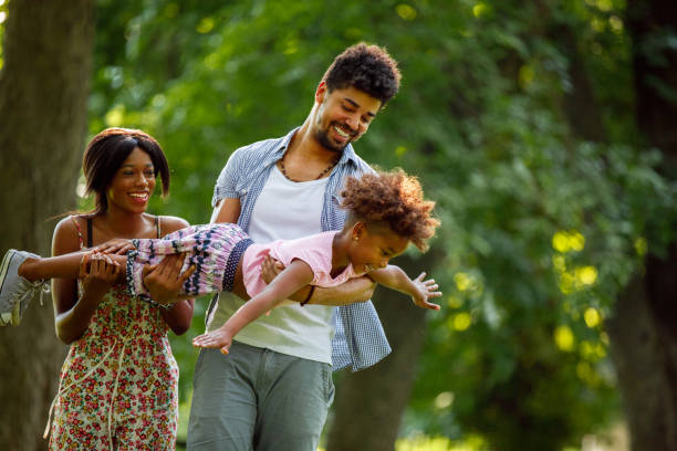 istock Father carrying his daughter and helping her fly 945479758