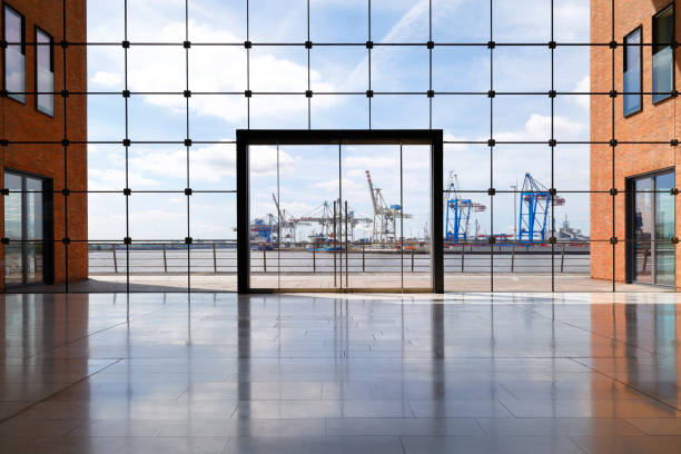 Hamburg, Germany -June 21, 2017. Container terminal of Hamburg harbor. View through lobby of an office building.