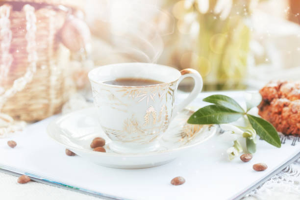 Cup of coffee, open diary or notebook, cookies and snowdrop flowers. Romantic breakfast.