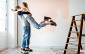 Cheerful couple renovating the house