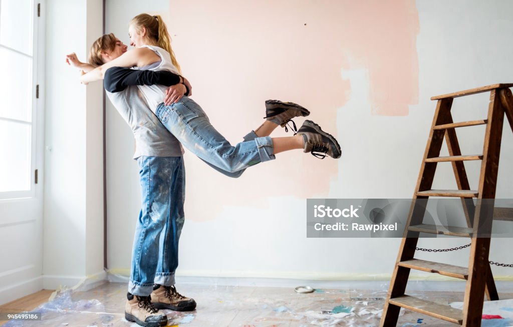 Cheerful couple renovating the house Couple - Relationship Stock Photo