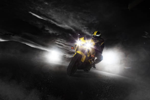 biker riding a classic sports motorcycle dressed in leather biker overalls