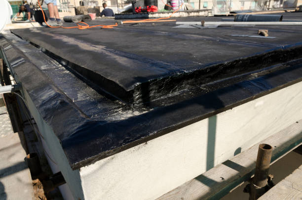 istock laying of waterproofing sheathing  and insulation on a roof 945519930