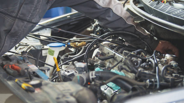 istock Man working with wiring on the dashboard at service station 945525160