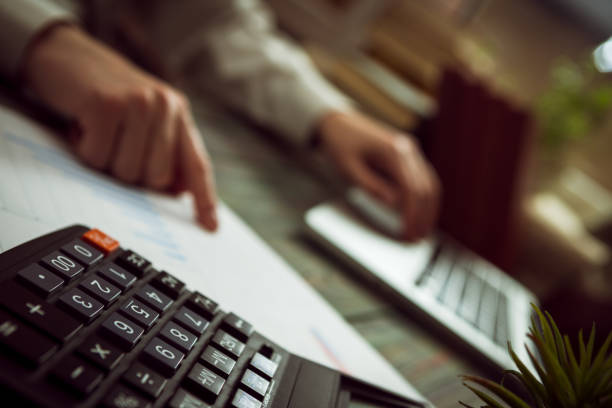 Business man calculate about cost and doing finance at office finance managers task concept