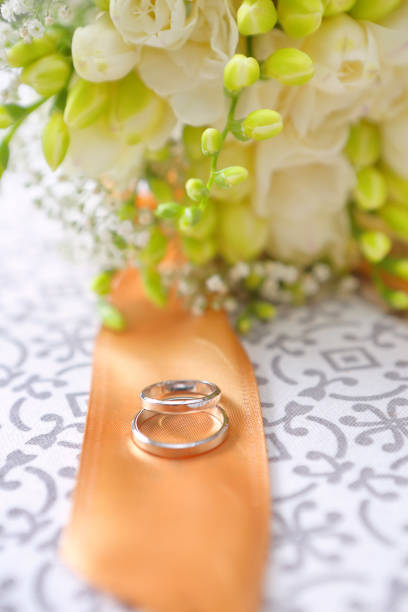 istock White Golden wedding rings on the table before wedding 945542762