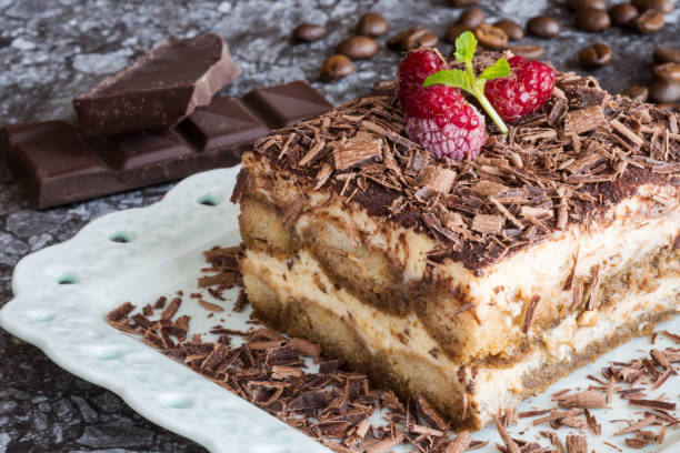 istock Homemade Tiramisu Cake Dessert with Grated Chocolate, Raspberry and Mint 945548416