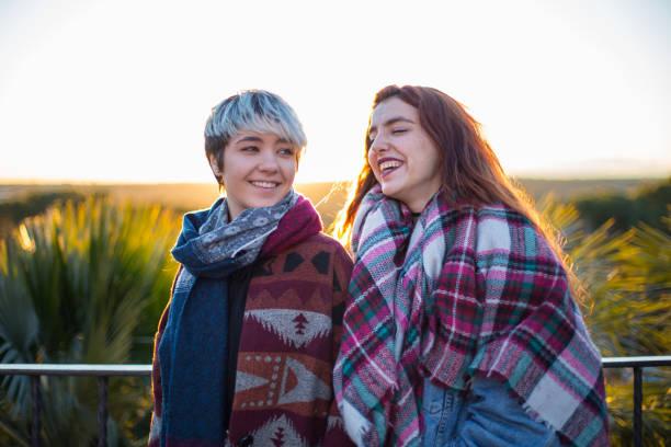 istock Content women in scarf laughing outside 945548966