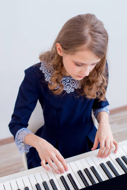 istock Girl playing synthesizer 945550362