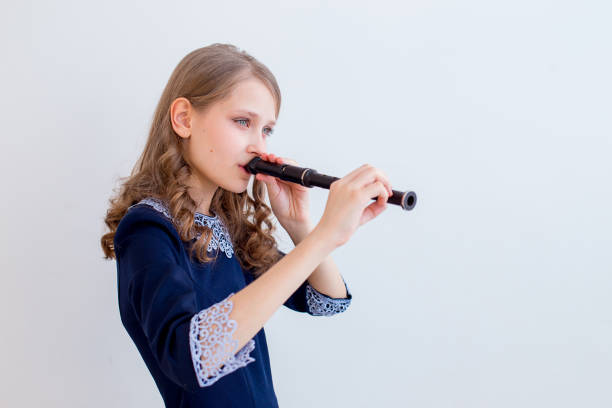 istock Girl playing on a flute 945550802