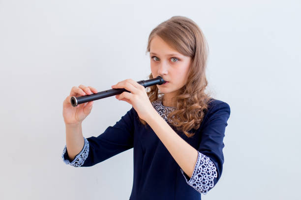 istock Girl playing on a flute 945550824