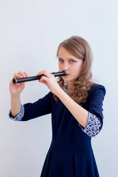 istock Girl playing on a flute 945550848