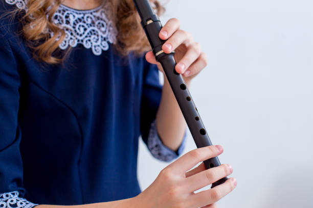 istock Girl playing on a flute 945550874