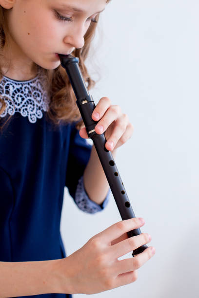 istock Girl playing on a flute 945550940