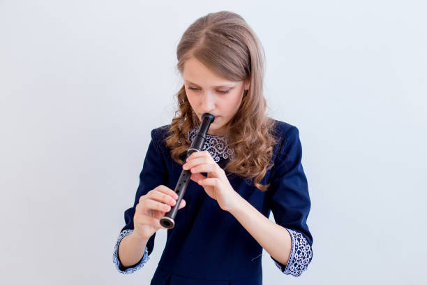 istock Girl playing on a flute 945551012