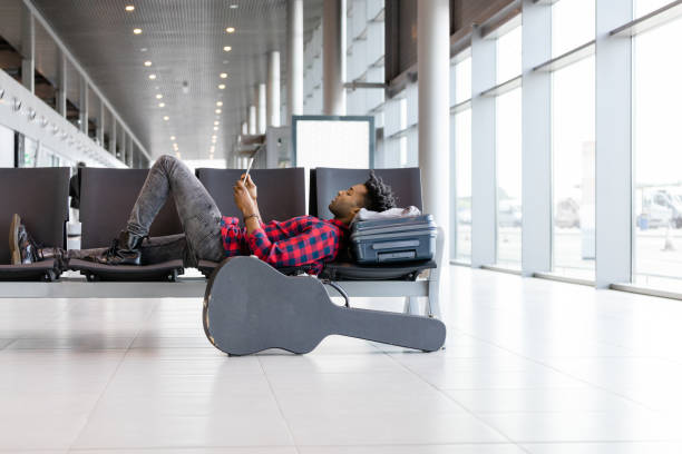 istock African man waiting for flight at airport lounge 945551070