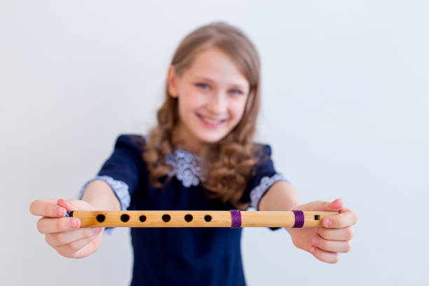A portrait of a girl playing on a flute