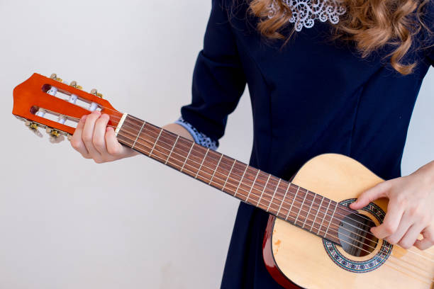 istock Girl playing a guitar 945556218