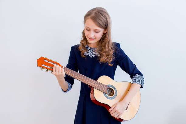 istock Girl playing a guitar 945556448