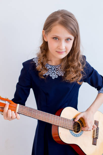 istock Girl playing a guitar 945556936