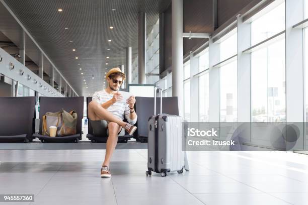 Man Using Digital Tablet In Airport Lounge Stock Photo - Download Image Now - Adult, Adults Only, Airport