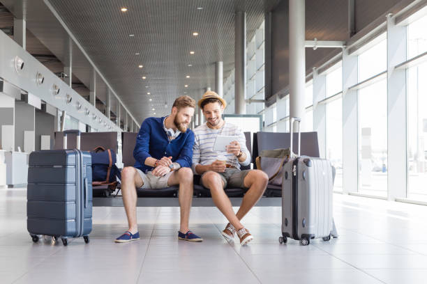 istock Friends waiting for flight in airport lounge 945560830